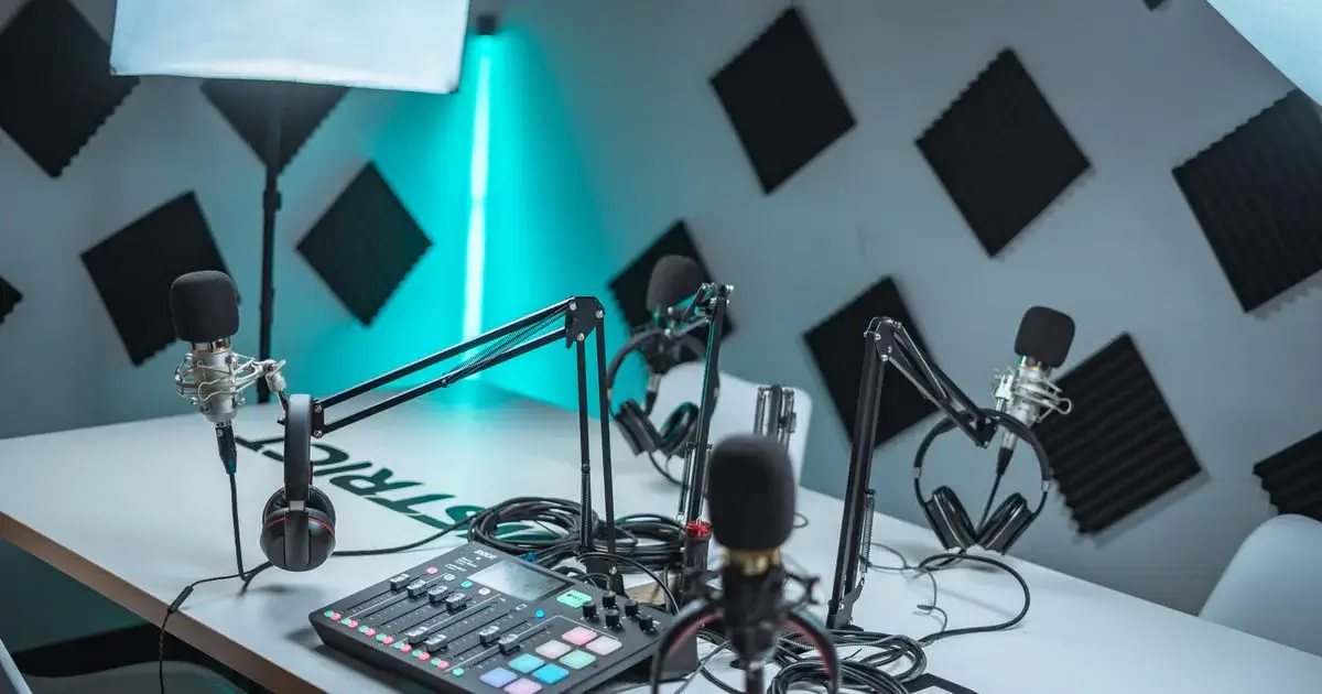 Podcast studio with microphones, headphones, and an audio mixer representing Reddit, YouTube, and off-site GEO content.